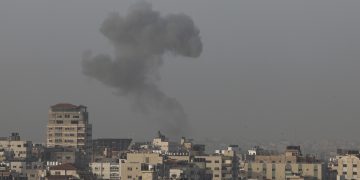 Smoke rises above buildings in Gaza City as Israel launched air strikes on the Palestinian enclave early on April 5, 2023. - After the announcement of the clashes at Al-Aqsa early on April 5, several rockets were fired from the northern Gaza Strip towards Israeli territory, according to AFP journalists and witnesses. The Israeli army said five rockets fired from the Gaza Strip were intercepted by the aerial defence system around Sderot in southern Israel, and that four others had fallen in uninhabited areas. Israeli fighter jets later struck two Hamas weapons manufacturing sites in the central Gaza Strip "in response" to the rocket fire, the army said. (Photo by Mohammed ABED / AFP)